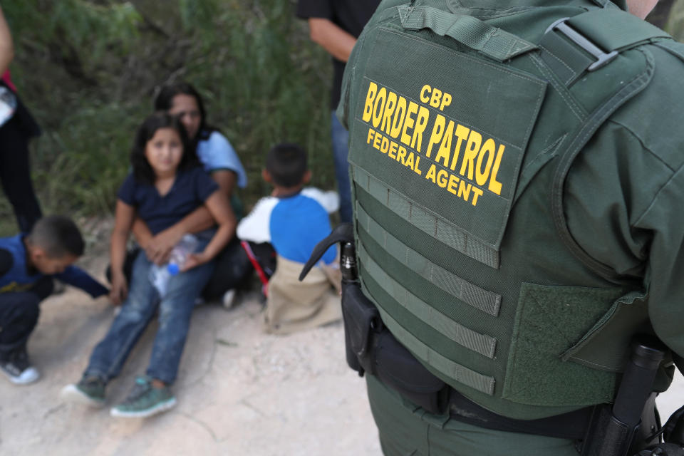 A Central American family waits to be taken into custody on June 12, 2018, near McAllen, Texas.