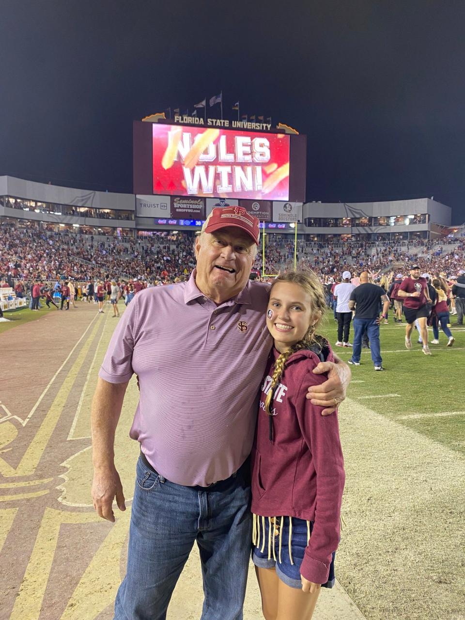 Jim McConnaughhay, 78, with granddaughter Emily McConnaughhay, 14, on the field at Doak Campbell Stadium following the Seminoles' win over the Florida Gators last month.