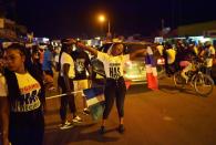 People celebrate in the streets after hearing of the confirmed departure of former Gambian leader Yahya Jammeh in Banjul on January 21, 2017