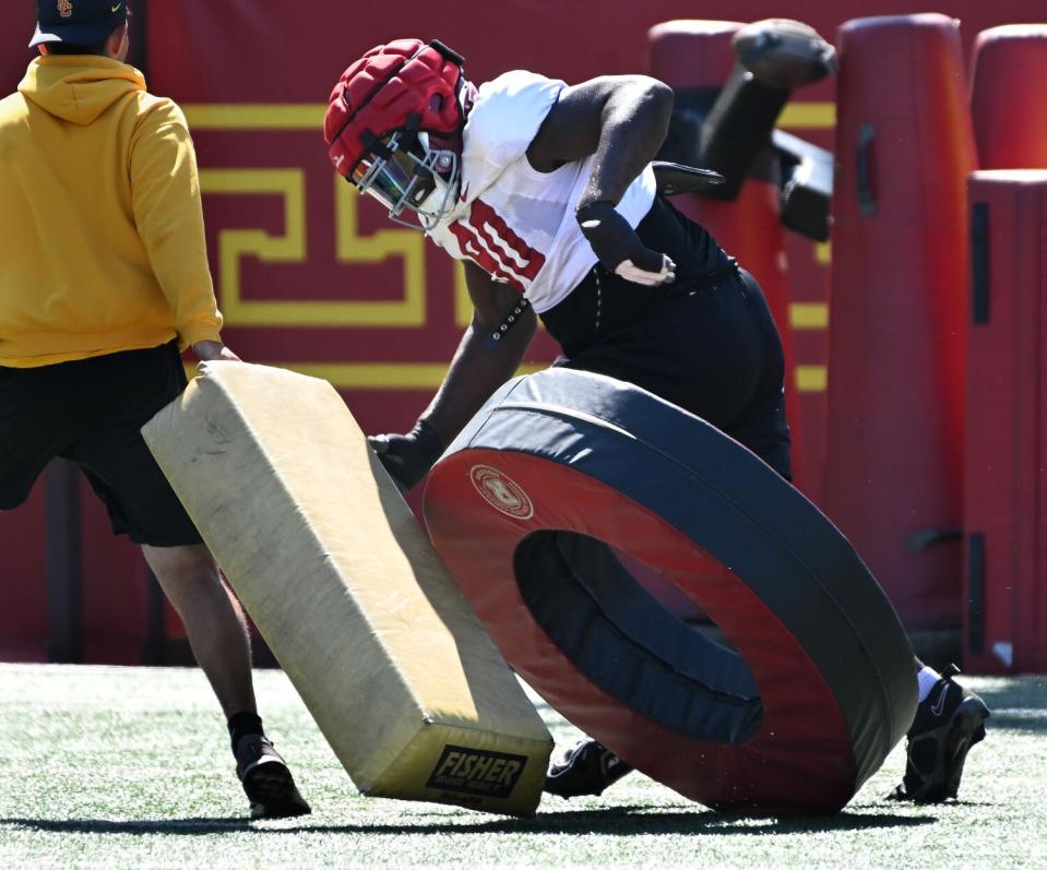 USC defensive lineman Bear Alexander pushes past pads during practice at Howard Jones Field