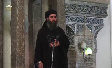 A man purported to be the reclusive leader of the militant Islamic State Abu Bakr al-Baghdadi has made what would be his first public appearance at a mosque in the centre of Iraq's second city, Mosul, according to a video recording posted on the Internet on July 5, 2014, in this still image taken from video. REUTERS/Social Media Website via Reuters TV