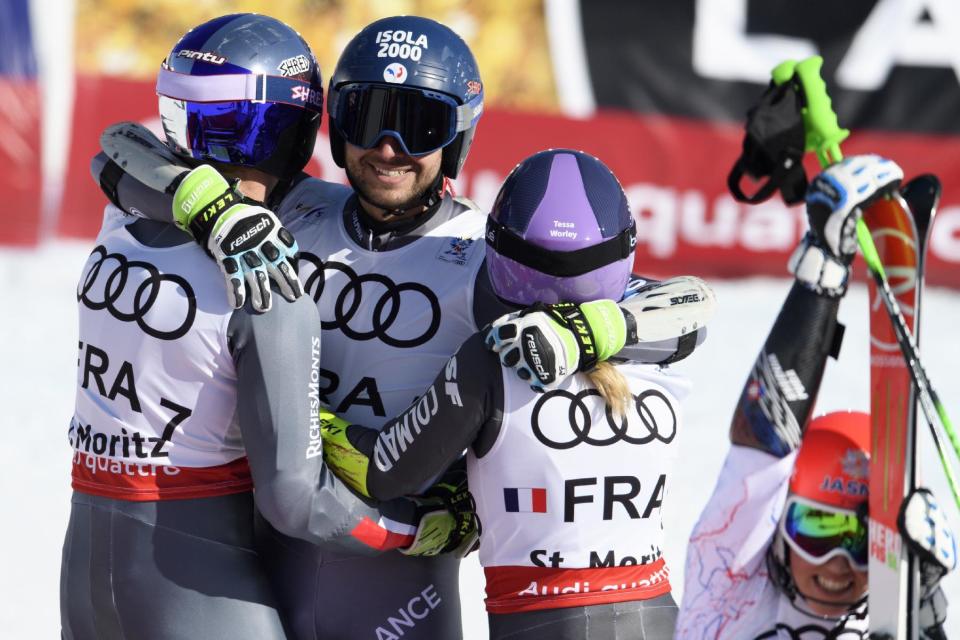 From left, gold medalists of France Alexis Pinturault, Mathieu Faivre and Tessa Worley celebrate in the finish area after the final of the team event at the 2017 FIS Alpine Skiing World Championships in St. Moritz, Switzerland, Tuesday, Feb. 14, 2017. (Gian Ehrenzeller/Keystone via AP)