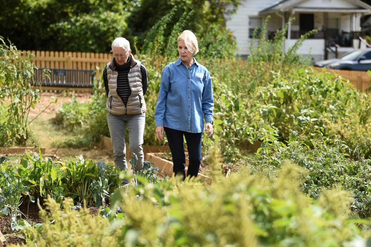 Cori Holmes and Barbra Bunting, members of Knox County Master Gardeners, attend the ribbon cutting.