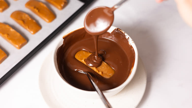 caramel bar in melted chocolate