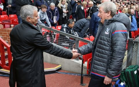 Manager Jose Mourinho of Manchester United greets Manager Roy Hodgson of Crystal Palace ahead of the Premier League match between Manchester United and Crystal Palace at Old Trafford on September 30, 2017 - Credit: John Peters/Man Utd via Getty Images