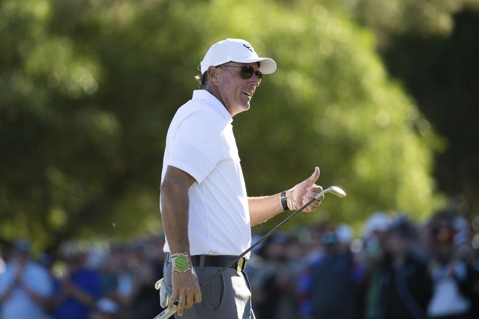 Captain Phil Mickelson of HyFlyers GC acknowledges the gallery on the 18th green during the first round of LIV Golf Adelaide at the Grange Golf Club, Friday, April 21, 2023, in Adelaide, Australia. (Montana Pritchard/LIV Golf via AP)