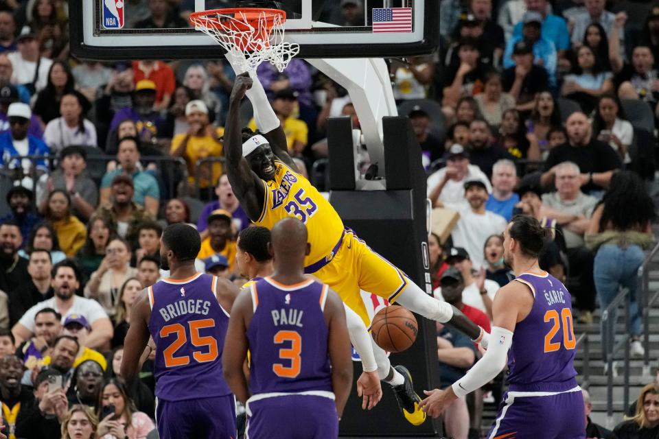 Los Angeles Lakers forward Wenyen Gabriel (35) dunks against the Phoenix Suns during the first half of a preseason NBA basketball game Wednesday, Oct. 5, 2022, in Las Vegas.