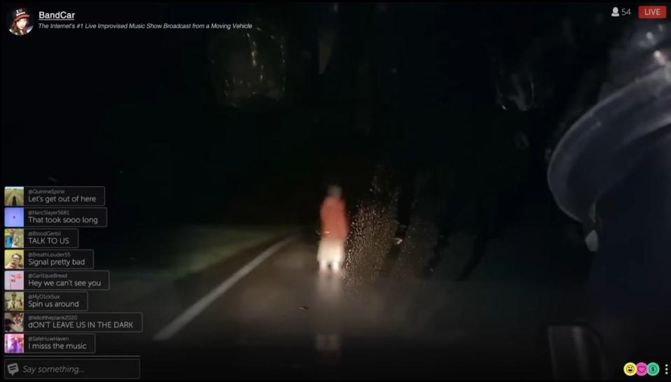 A woman stands in a dark road during a streaming webcast in "Dashcam"