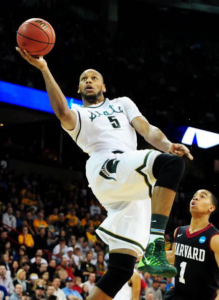 Adreian Payne #5 of the Michigan State Spartans shoots over Siyani Chambers #1 of the Harvard Crimson in the first half during the Third Round of the 2014 NCAA Basketball Tournament at Spokane Veterans Memorial Arena on March 22, 2014 in Spokane, Washington.  (Photo by Steve Dykes/Getty Images)