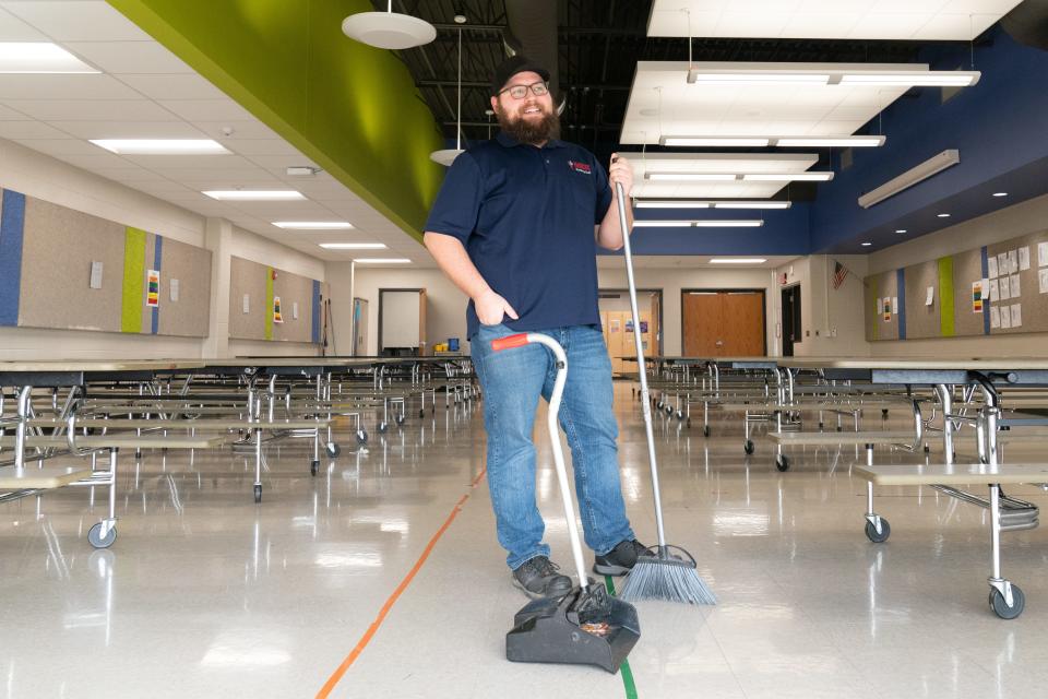 Austin Smith, head custodian at Berryton Elementary School, takes a moment from sweeping trash inside the cafeteria Feb. 21. Smith is nominated for the 5th annual Tennant Co.'s "Custodians are Key contest" this year.