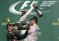 Formula One F1 - U.S. Grand Prix - Circuit of the Americas, Austin, Texas, U.S., 23/10/16. Mercedes' Lewis Hamilton of Britain celebrates his victory with second placed finisher and teammate Nico Rosberg of Germany (R) and third placed Red Bull's Daniel Ricciardo of Australia (L) during the victory ceremony. REUTERS/Adrees Latif