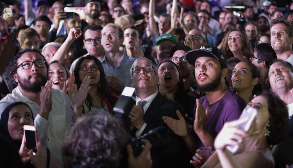 New York City Comptroller Scott Stringer, center, watches poll results with supporters at the campaign headquarters of Queens district attorney candidate Tiffany Caban Tuesday, June 25, 2019, in the Queens borough of New York. (AP Photo/Frank Franklin II)