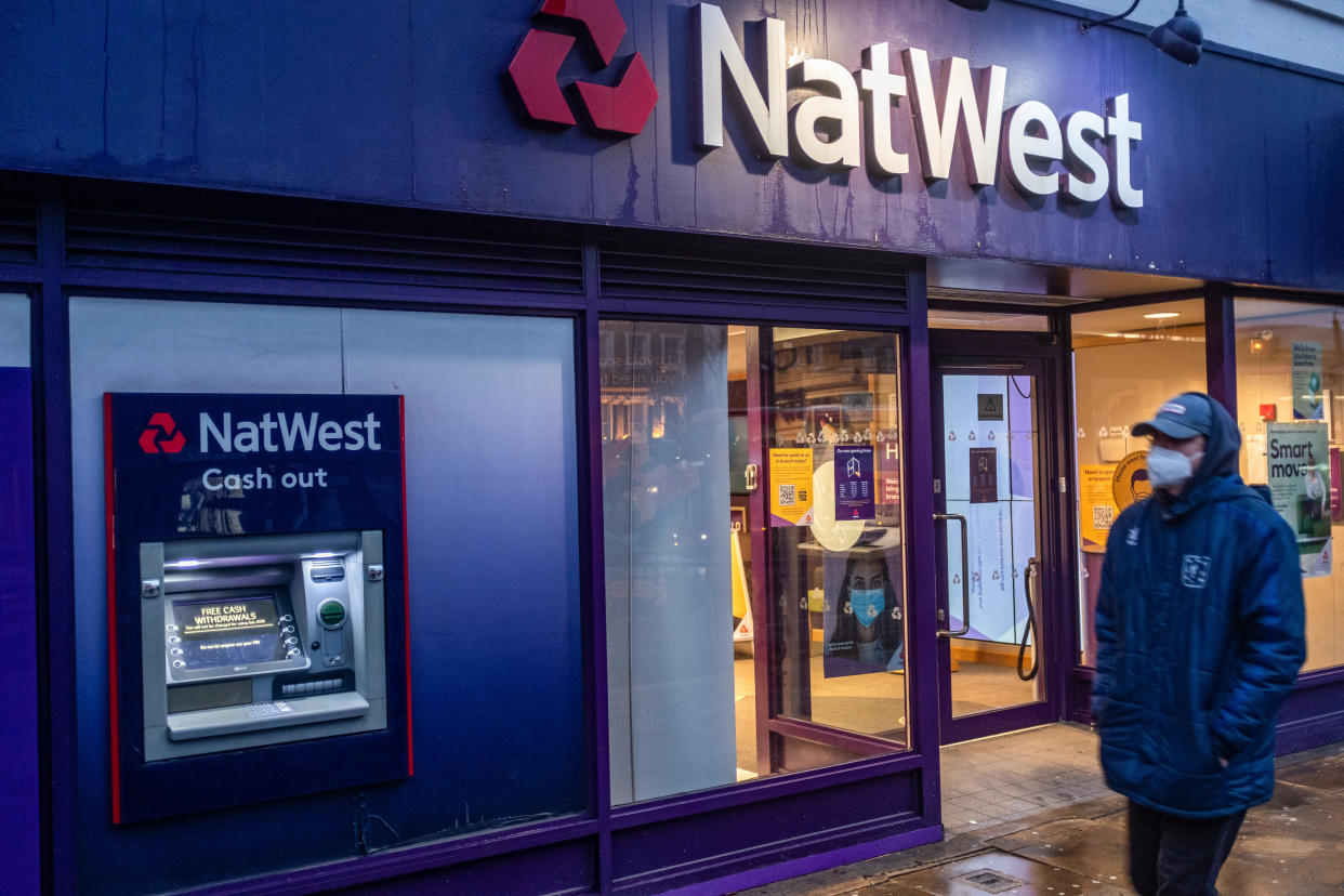 LONDON, UNITED KINGDOM - 2021/01/15: A man wearing a facemask as a preventive measure against the Covid-19 coronavirus walks past a branch of NatWest Bank in London. (Photo by May James/SOPA Images/LightRocket via Getty Images)