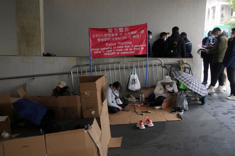 FILE PHOTO: Police officers disperse domestic workers gathering on their rest day, during the coronavirus disease (COVID-19) outbreak in Hong Kong, China