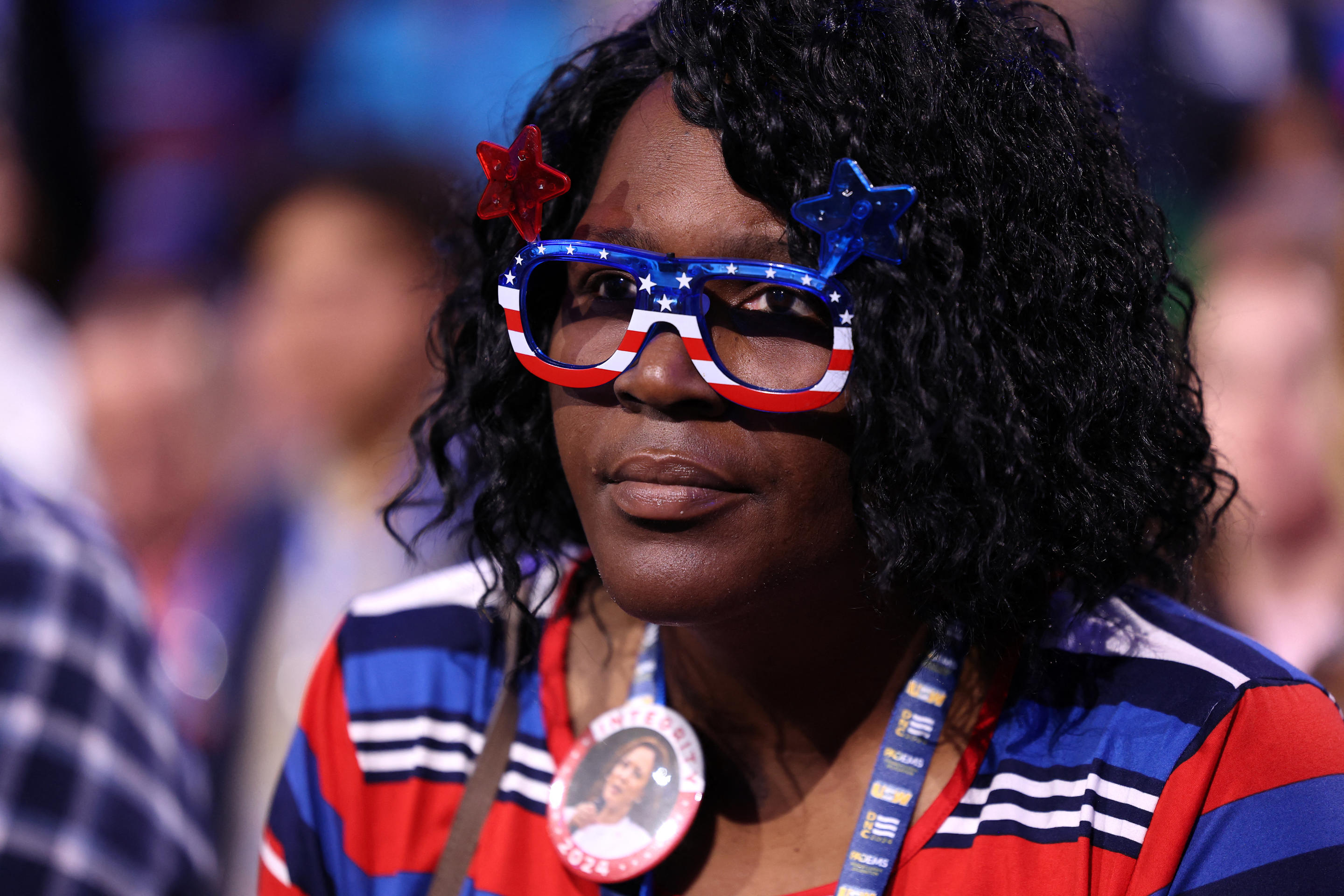 A woman with red, white and blue glasses looks on the second day of the Democratic National Convention in Chicago. (Charly Triballeau/AFP via Getty Images)