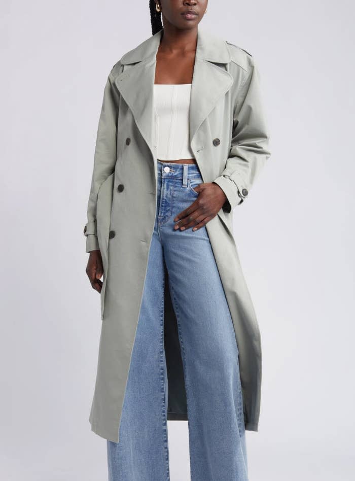 model wearing light grey trench coat