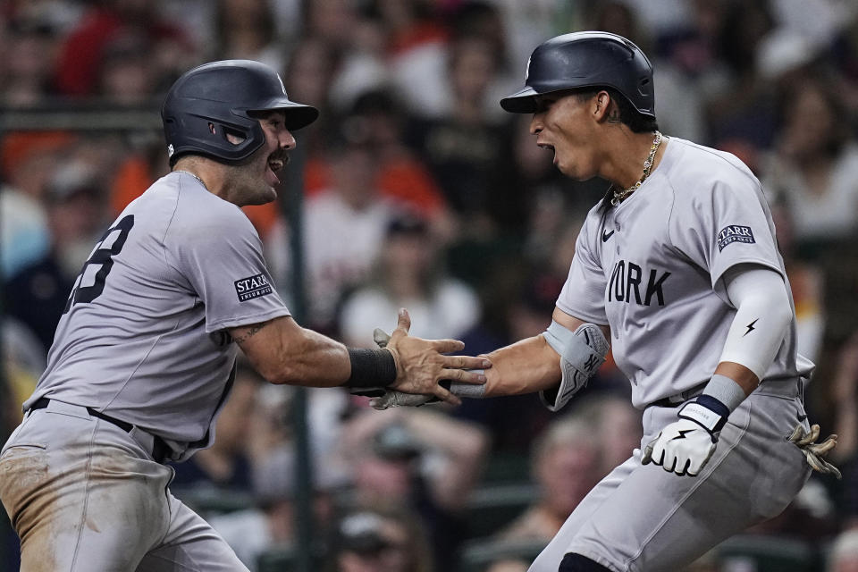 New York Yankees' Oswaldo Cabrera, right, celebrates with Austin Wells after hitting a two-run home run against the Houston Astros during the seventh inning of a baseball game Saturday, March 30, 2024, in Houston. (AP Photo/Kevin M. Cox)