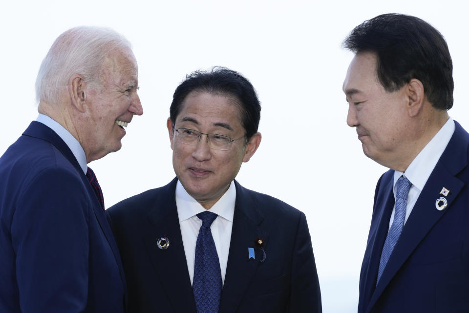 President Joe Biden, left, talks with Japan's Prime Minister Fumio Kishida and South Korean President Yoon Suk Yeol, right, ahead of a trilateral meeting on the sidelines of the G7 Summit in Hiroshima, Japan, Sunday, May 21, 2023. (AP Photo/Susan Walsh)
