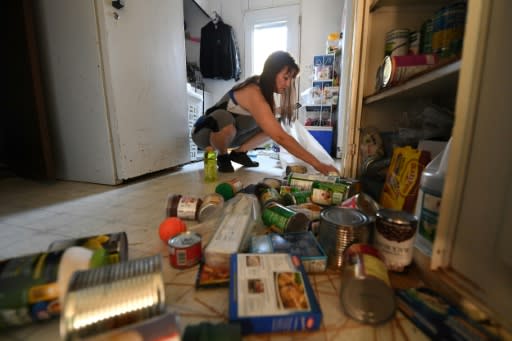 Tammy Sears cleans up her kitchen after a magnitude 7.1 earthquake struck Ridgecrest, California, on July 6, 2019