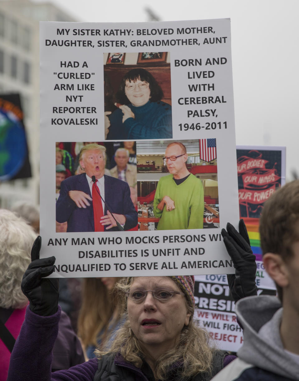 WASHINGTON, DC - JANUARY 21: A marcher attending the Women's March on Washington holds up a sign criticizing President Trump's treatment of a physically challenged New York Times reporter Serge Kovaleski on January 21, 2017 in Washington, DC. (Photo by Robert Nickelsberg/Getty Images)