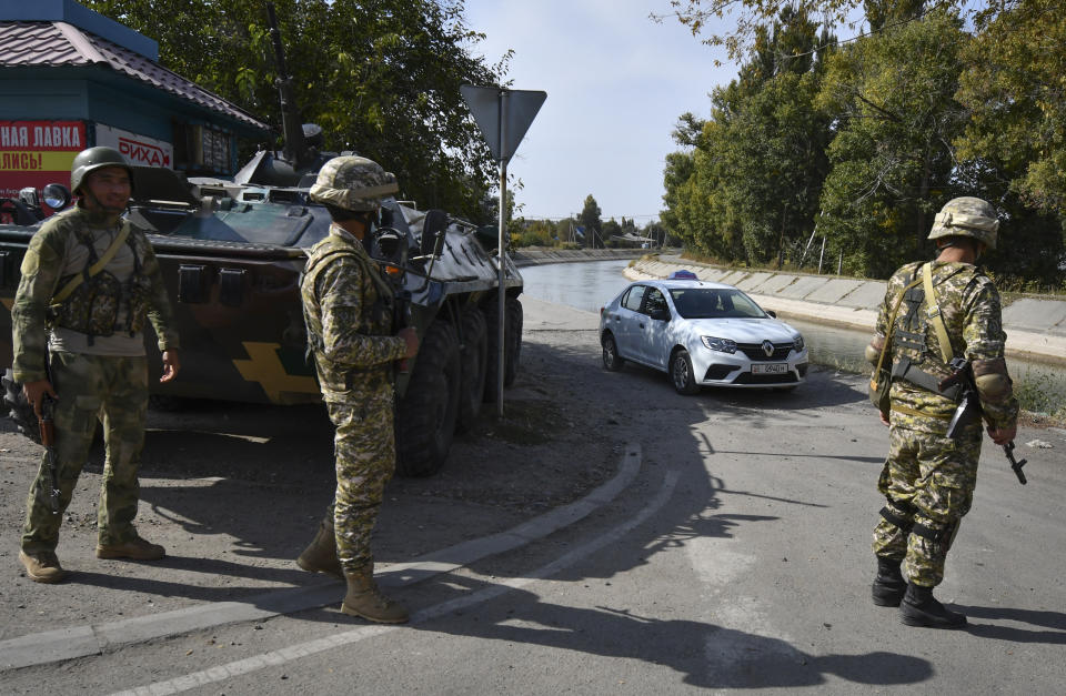 Soldiers of Kyrgyz army stand at checkpoint on city street in Bishkek, Kyrgyzstan, Saturday, Oct. 10, 2020. President Sooronbai Jeenbekov decreed the state of emergency in the capital and ordered the military to deploy troops to Bishkek to enforce the measure. (AP Photo/Vladimir Voronin)