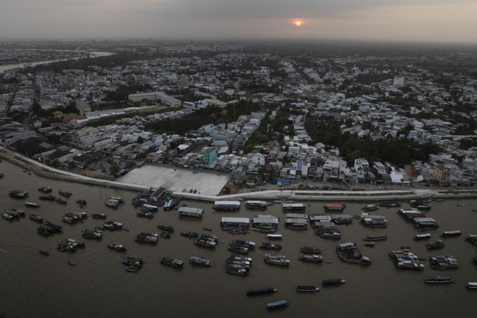 Boats crowd on a floating market as the sun rises in Can Tho, Vietnam, Wednesday, Jan. 17, 2024. (AP Photo/Jae C. Hong)