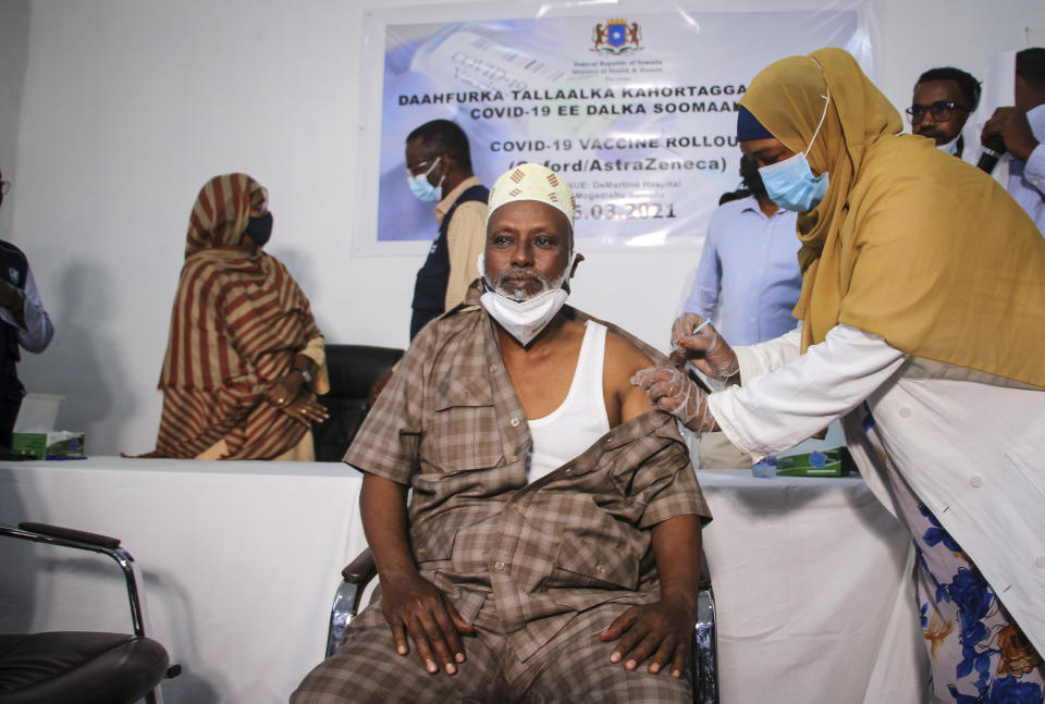 FILE - In this March 16, 2021, file photo, Dr. Maxamed Maxamuud Fuje receives a shot of AstraZeneca COVID-19 vaccine provided through the global COVAX initiative, at a ceremony to mark the start of coronavirus vaccinations in Mogadishu, Somalia. The suspension of the AstraZeneca vaccine in several European countries could fuel skepticism about the shot far beyond their shores, potentially threatening the rollout of a vaccine that is key to the global strategy to stamp out the coronavirus pandemic, especially in developing nations. (AP Photo/Farah Abdi Warsameh, File)