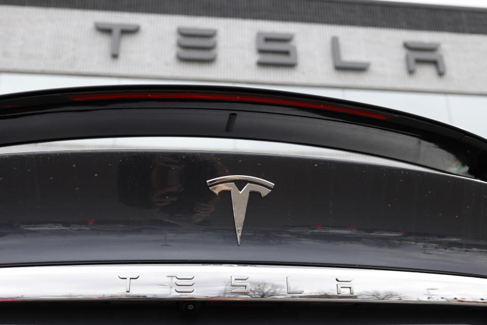 FILE - The Tesla company logo shines off the rear deck of an unsold 2020 Model X at a Tesla dealership, April 26, 2020, in Littleton, Colo. Tesla is recalling more than 2 million vehicles across its model lineup to fix a defective system that’s supposed to ensure drivers are paying attention when they use Autopilot. Documents posted by U.S. safety regulators say the company will send out a software update to fix the problems. (AP Photo/David Zalubowski, File)