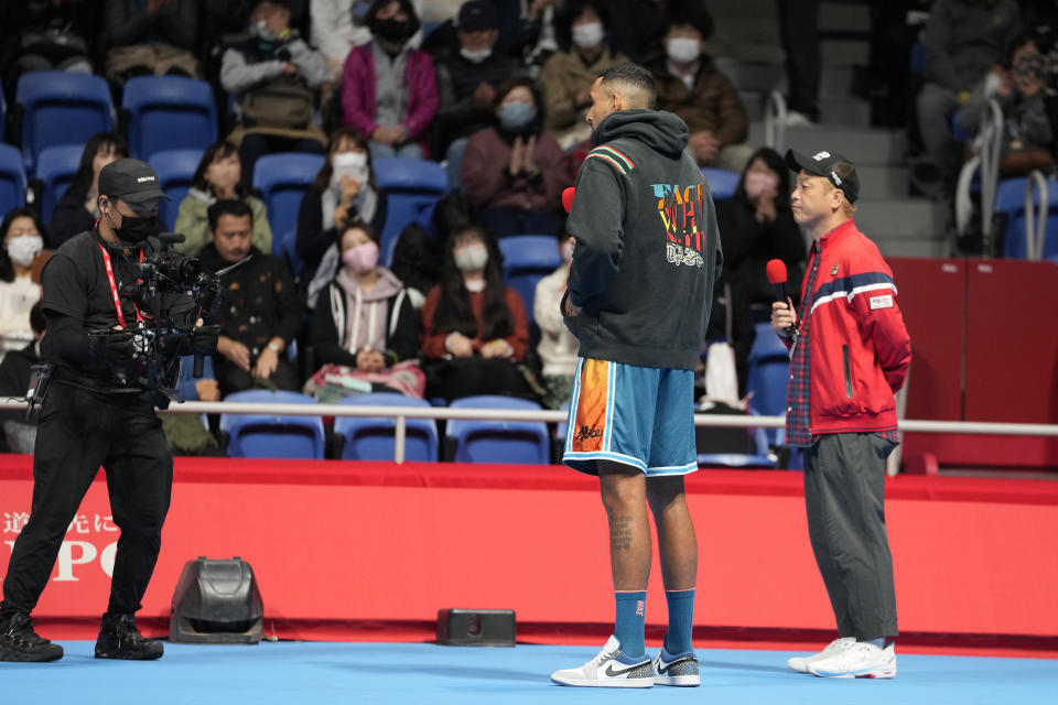 Nick Kyrgios, center, of Australia speaks on a court as he withdrew from the singles match against Taylor Fritz of the U.S. in the Rakuten Open tennis championships at Ariake Colosseum Friday, Oct. 7, 2022, in Tokyo. (AP Photo/Shuji Kajiyama)