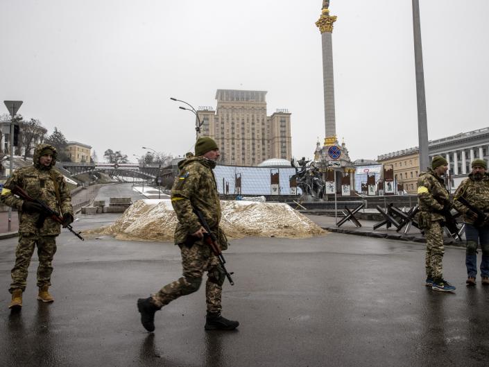 Soldiers are seen around piles of sand used for blocking a road in Ukrainian capital, Kyiv amid Russian attacks on March 02, 2022.