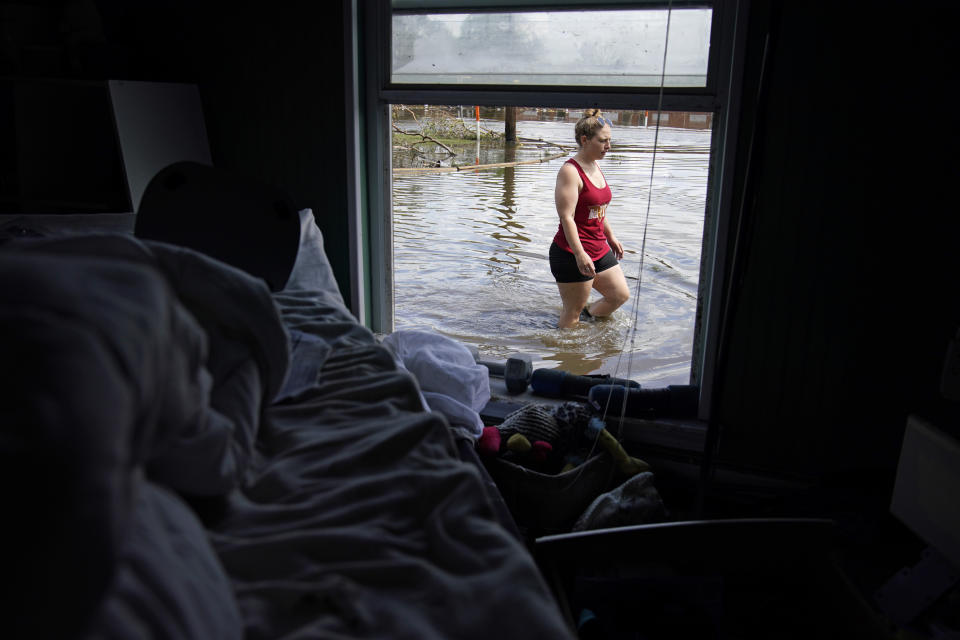 Emily Francois walks through floodwater beside her flood-damaged home in the aftermath of Hurricane Ida on in Jean Lafitte, La. 