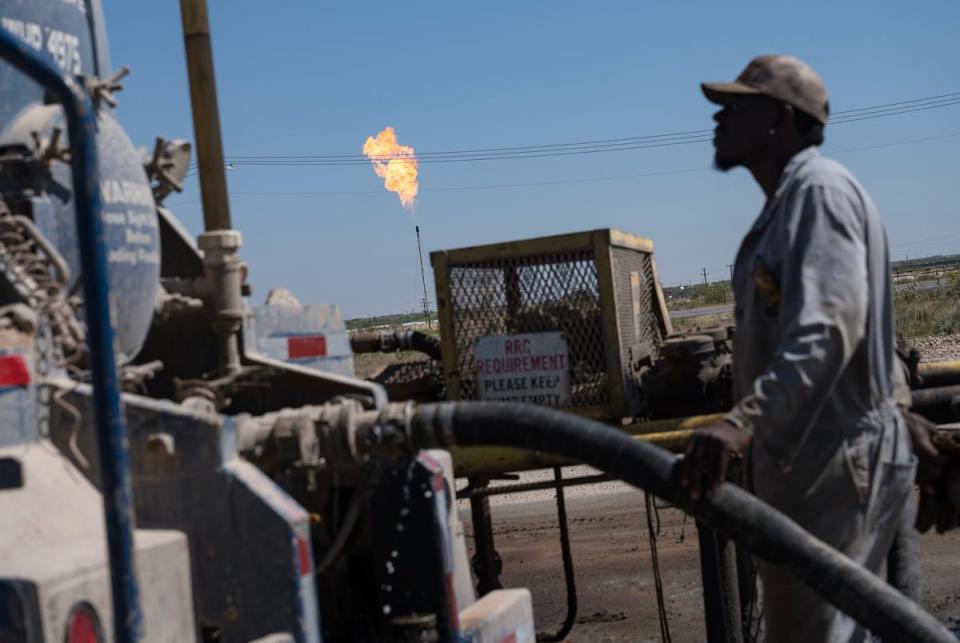 Brandon Horton, a driver for Allied Eagle Transports, monitors the transfer of a load of salt water, a byproduct of fracking, to a salt water disposal site Tuesday, June 25, 2024, south of Midland.