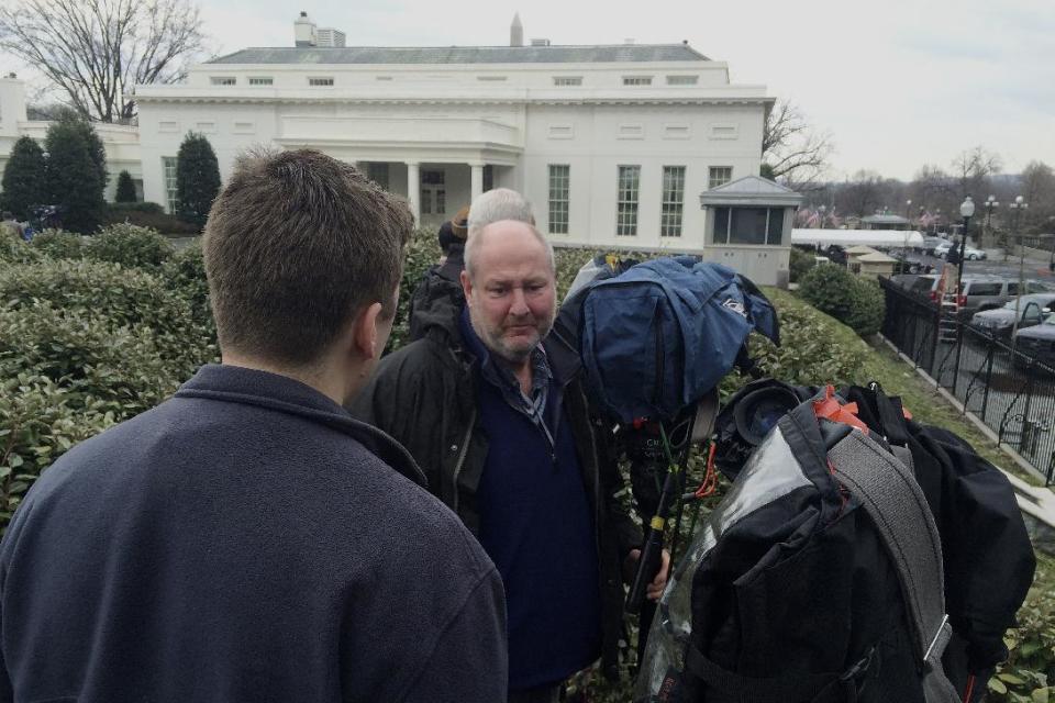 Television news cameramen point their cameras to the West Wing entrance of the White House in Washington, Friday, Feb. 21, 2014, hoping to catch Tibetan spiritual leader the Dalai Lama arriving for a closed press meeting with President Barack Obama. (AP Photo/Charles Dharapak)