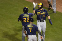 Milwaukee Brewers' Christian Yelich (22) celebrates with teammates Keston Hiura (18) and Eric Sogard (7) after hitting a three-run home run during the sixth inning of a baseball game against the Chicago Cubs, Friday, Aug. 14, 2020, in Chicago. (AP Photo/Jeff Haynes)