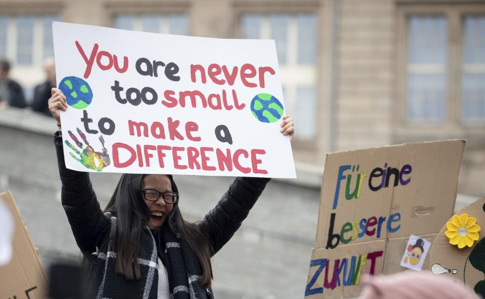 A young girl attends a protest rally of the 'Friday For Future Movement' in Berlin, Germany, Friday, March 29, 2019. Thousands of students are gathering in the German capital, skipping school to take part in a rally demanding action against climate change. (Kay Nietfeld/dpa via AP)