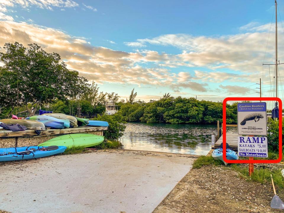 The boat ramp has a sign that says to watch for manatees