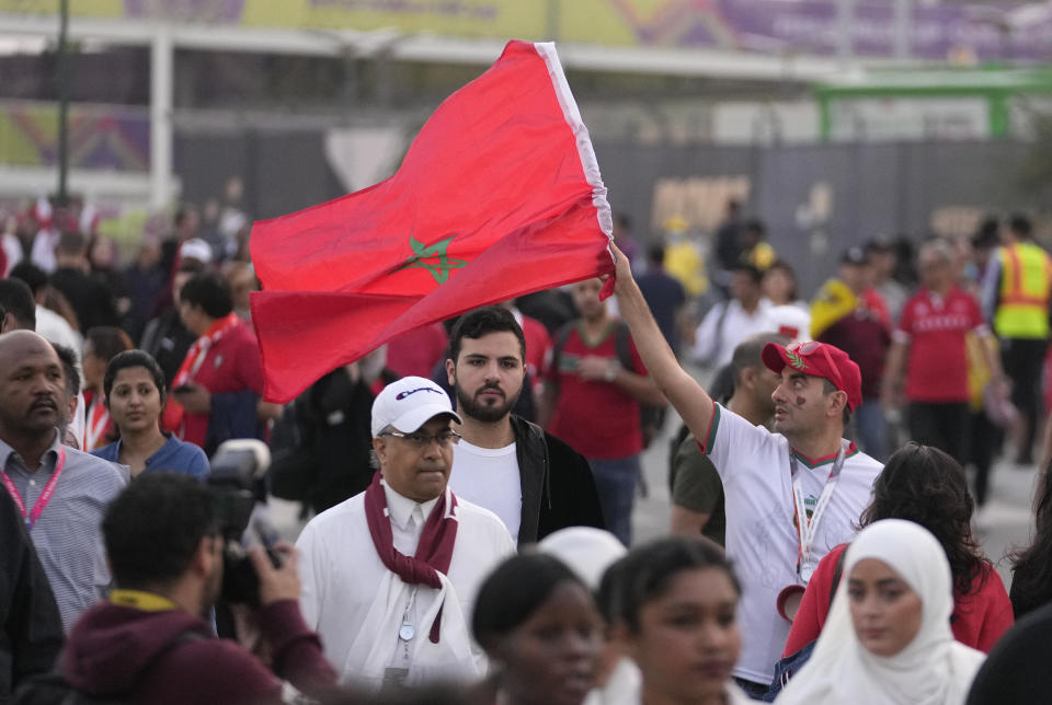 A Moroccan supporter waves his national flag as he arrives ahead of the World Cup quarterfinal soccer match between Morocco and Portugal, at Al Thumama Stadium in Doha, Qatar, Saturday, Dec. 10, 2022. (AP Photo/Jorge Saenz)