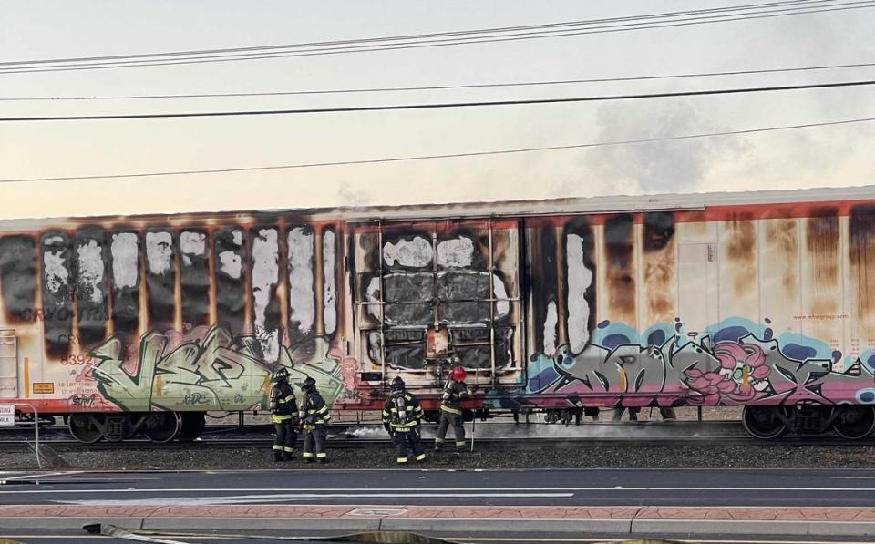 Firefighters respond to a freight train fire near Highway 132 in Modesto on Tuesday, April 9, 2024.