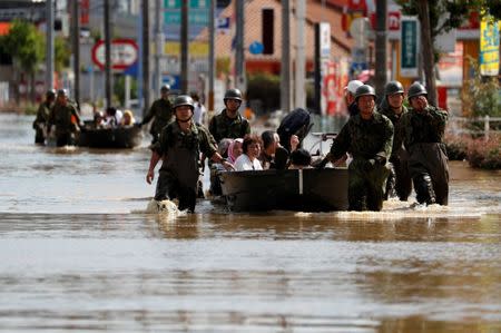 Japan Self-Defence Force soldiers rescue people from a flooded area in Mabi town in Kurashiki, Okayama Prefecture, Japan, July 8, 2018. REUTERS/Issei Kato