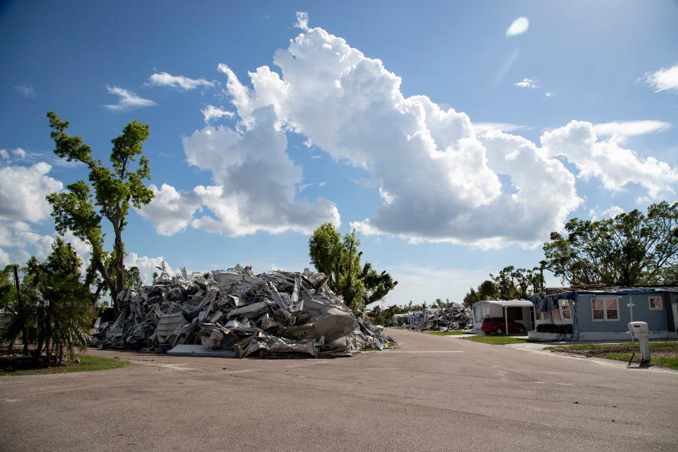 Workers have begun to clear the yards of metal and household items in Century 21 mobile home park in south Fort Myers. Now there are huge piles of debris in the neighborhood. The entire neighborhood and the surrounding area were flooded in Hurricane Ian. The park was also hit by a tornado earlier this year, so many residents were still recovering from that.