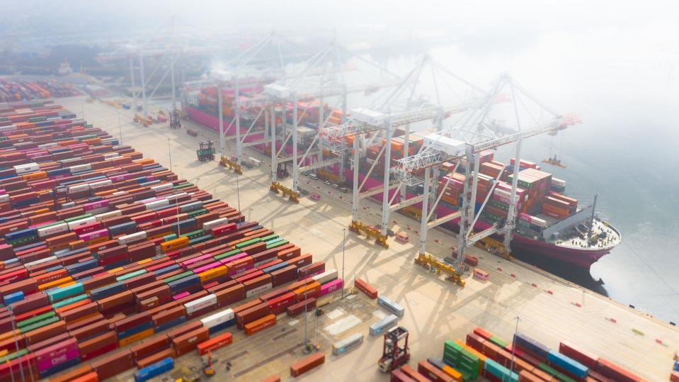 Container ship being loaded in port, UK