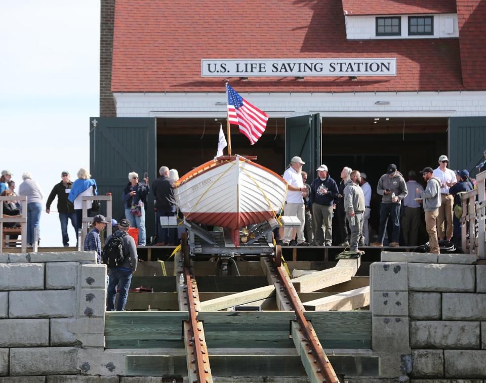 The fully restored 1930s rescue boat Mervin F Roberts was relaunched Sept. 30, 2022 as an 8 person crew plus a coxswain rowed her to Wood Island U.S. Life Saving Station.