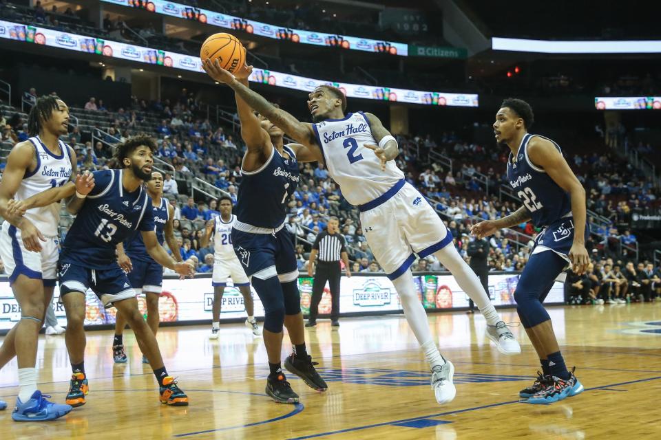 Seton Hall Pirates guard Al-Amir Dawes (2) goes past St. Peter's Peacocks guard Brent Bland (1) for a lay up in the second half at Prudential Center.