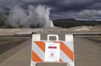A sign announces the closure of the Old Faithful geyser in Yellowstone National Park in Wyoming Oct. 1, 2013, in the wake of the government shutdown. U.S. President Barack Obama scaled back a long-planned trip to Asia on October 2, 2013 and planned a meeting with Democratic and Republican leaders in Congress that both sides said was unlikely to yield an end to the government shutdown. Picture taken October 1, 2013. REUTERS/Christopher Cauble (UNITED STATES - Tags: POLITICS TRAVEL)