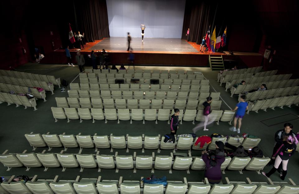 In this Sept. 5, 2012 photo, ballet dancers prepare for a competition between ballet schools at the National Museum in Lima, Peru. Nearly 100 girls and boys from Colombia, Venezuela, Chile, France and Peru are submitting themselves to a week-long competition hoping to win medals from Peru's national ballet school _ and perhaps a grant to study in Miami. (AP Photo/Martin Mejia)