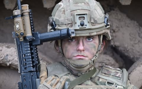 Royal Army Veterinary Corps Dog Handler Private Beth Johnson, 19, from Bridgwater during a Land Combat demonstration featuring women in command posts at Copehill Down Village on Salisbury Plain, Wiltshire. - Credit: Ben Birchall / PA