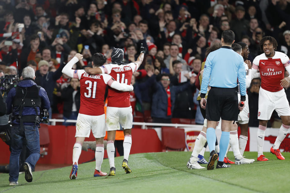 Arsenal's Pierre-Emerick Aubameyang, center, celebrates after scoring his side's third goal during the Europa League round of 16, 2nd leg, soccer match between Arsenal and Rennes at the Emirates stadium in London, Thursday, March 14, 2019. (AP Photo/Alastair Grant)