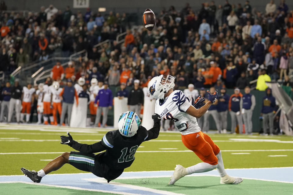 UTSA wide receiver David Amador can't pull in a pass in the end zone as he is covered by Tulane defensive back DJ Douglas (12) in the second half of an NCAA college football game in New Orleans, Friday, Nov. 24, 2023. Tulane won 29-16. (AP Photo/Gerald Herbert)