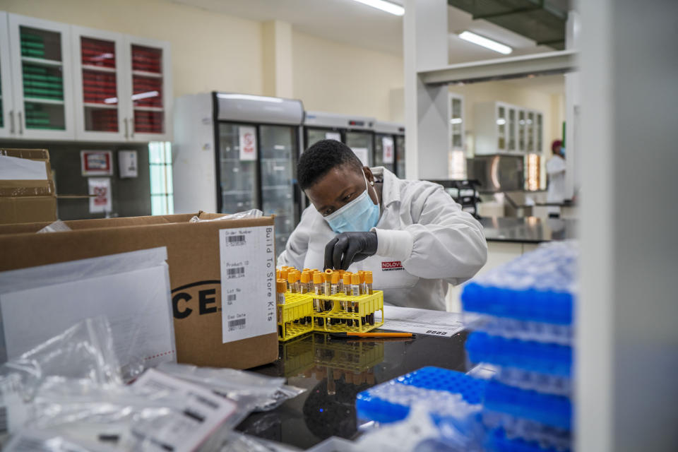 A lab technician works on blood samples taken from people taking part in a Johnson & Johnson Covid-19 vaccine test at the Ndlovu clinic's lab in Groblersdal, South Africa, 200 kms north-east of Johannesburg Thursday Feb. 11, 2021. African countries without the coronavirus variant dominant in South Africa should go ahead and use the AstraZeneca COVID-19 vaccine, the Africa Centers for Disease Control and Prevention said Thursday, while the World Health Organization suggested the vaccine even for countries with the variant circulating widely.(AP Photo/Jerome Delay)