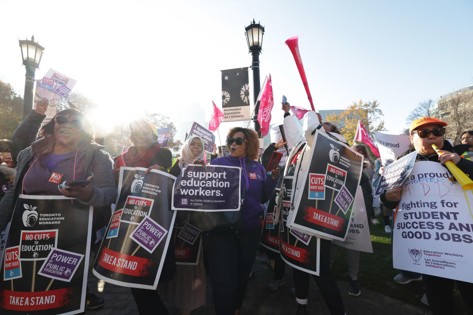 Members of CUPE education workers and other supporters amass at Queens Park to protest a day after the Provincial Government enacted the Not Withstanding Clause of the Canadian Constitution to legislate a contract on the union